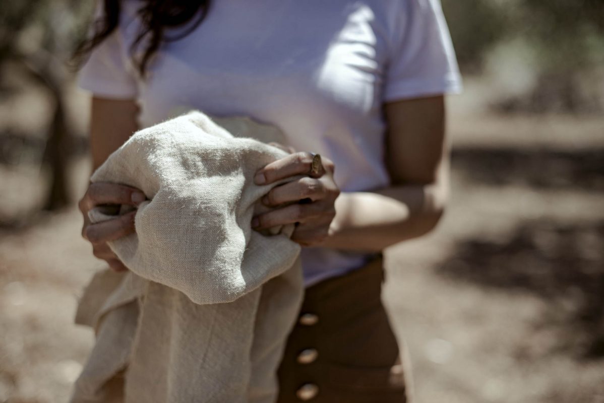 Ragazza che stringe tra le mani un tessuto in canapa